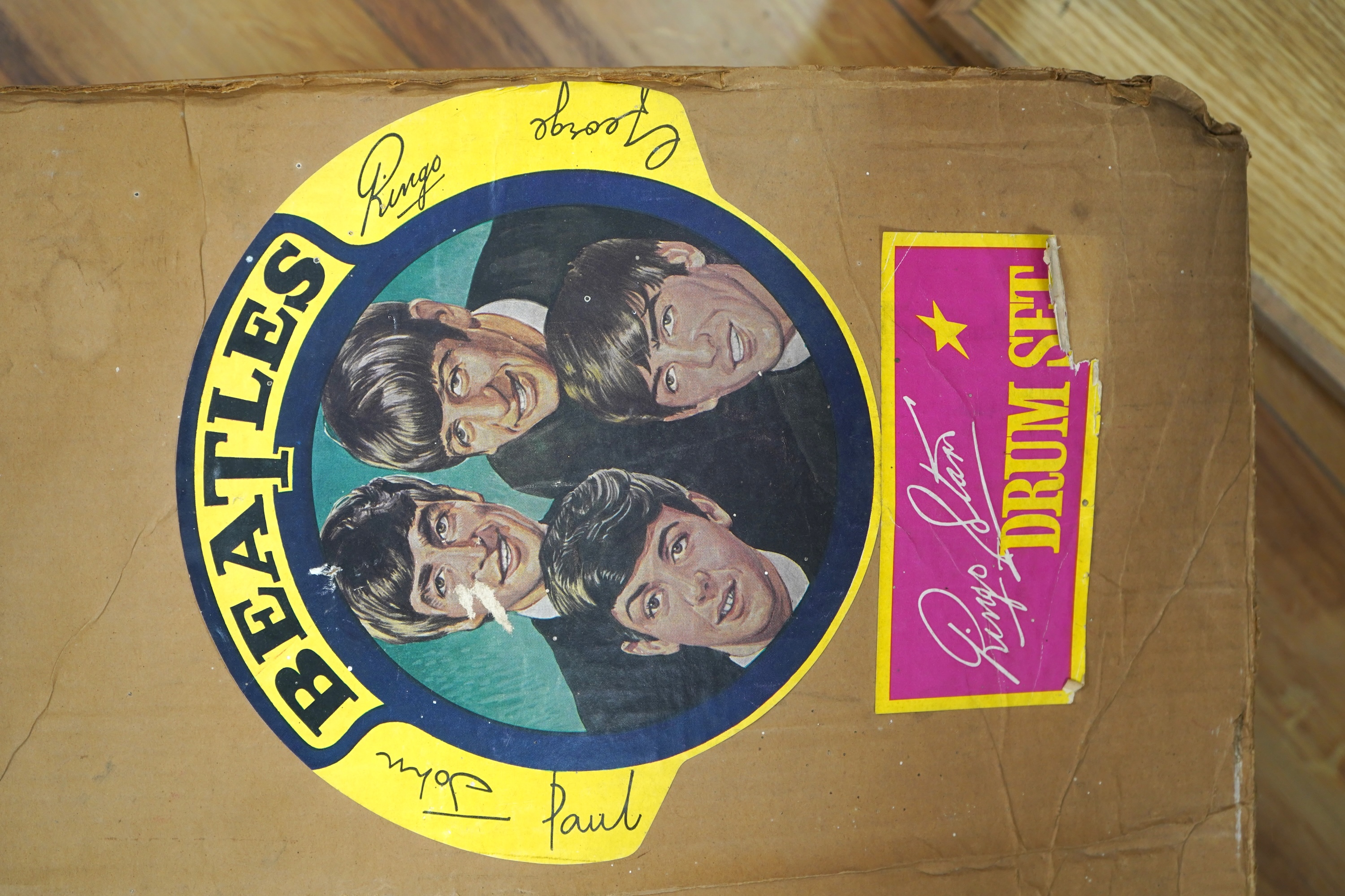 A 1960's Beatles child's plastic drum set in the original card box comprising of a snare drum on a stand, a card cut out bust of Ringo Starr, two 1960s Beatles jigsaws (unchecked) and a Beatles inflatable ball